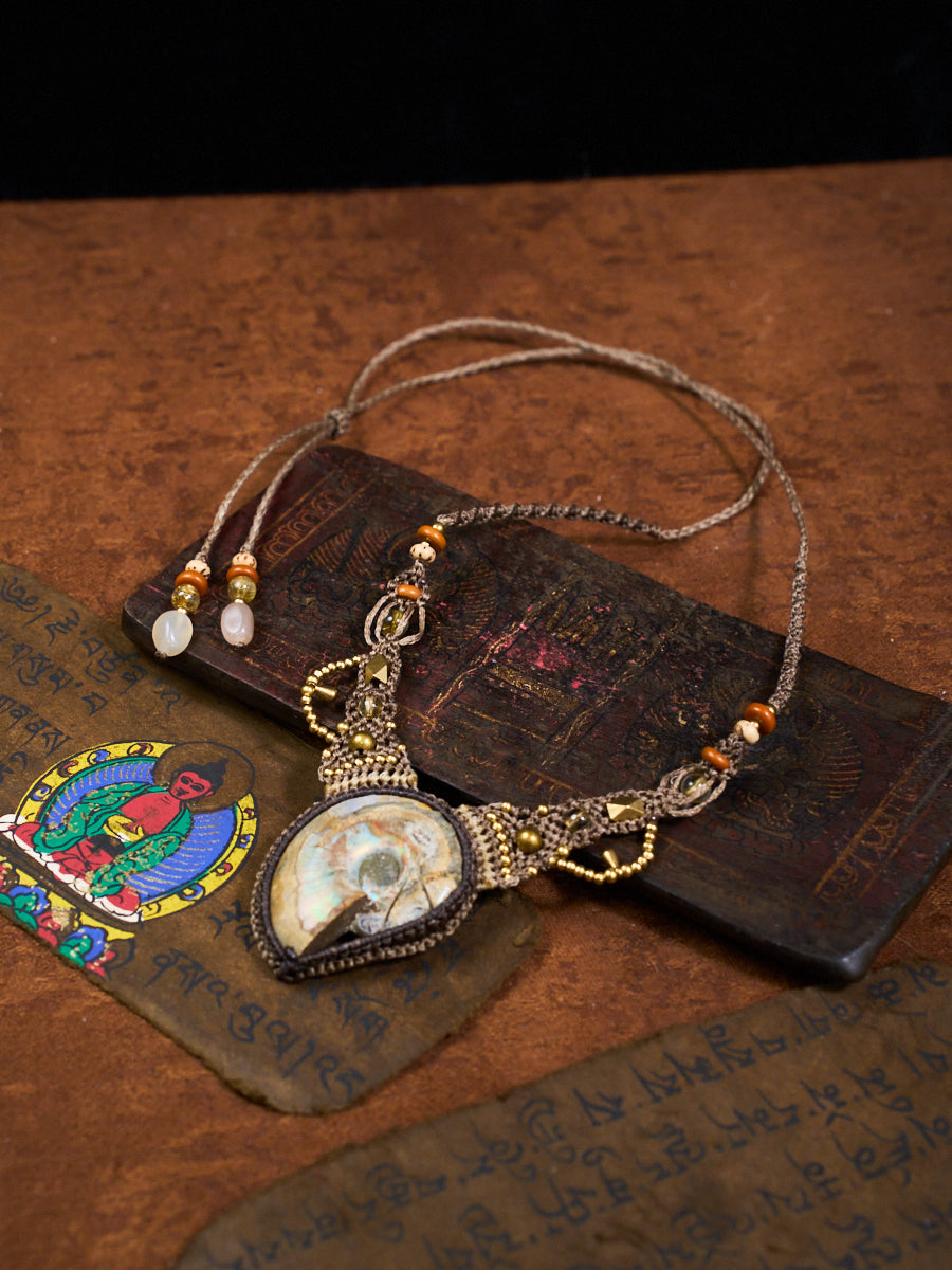 Decorative necklace with pendant on a textured surface