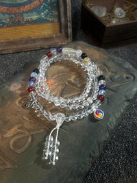 Stack of beaded bracelets with colorful beads on a textured surface