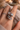 Close-up of a hand wearing two crystal rings with a soft, blurred background.