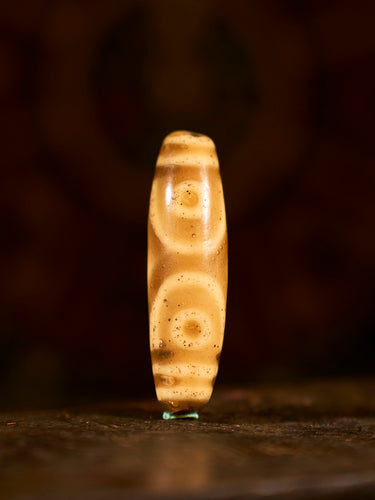 Glass “Three-Eyed Treasure Canopy” Dzi Bead