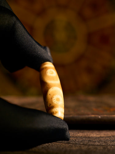 Glass “Three-Eyed Treasure Canopy” Dzi Bead